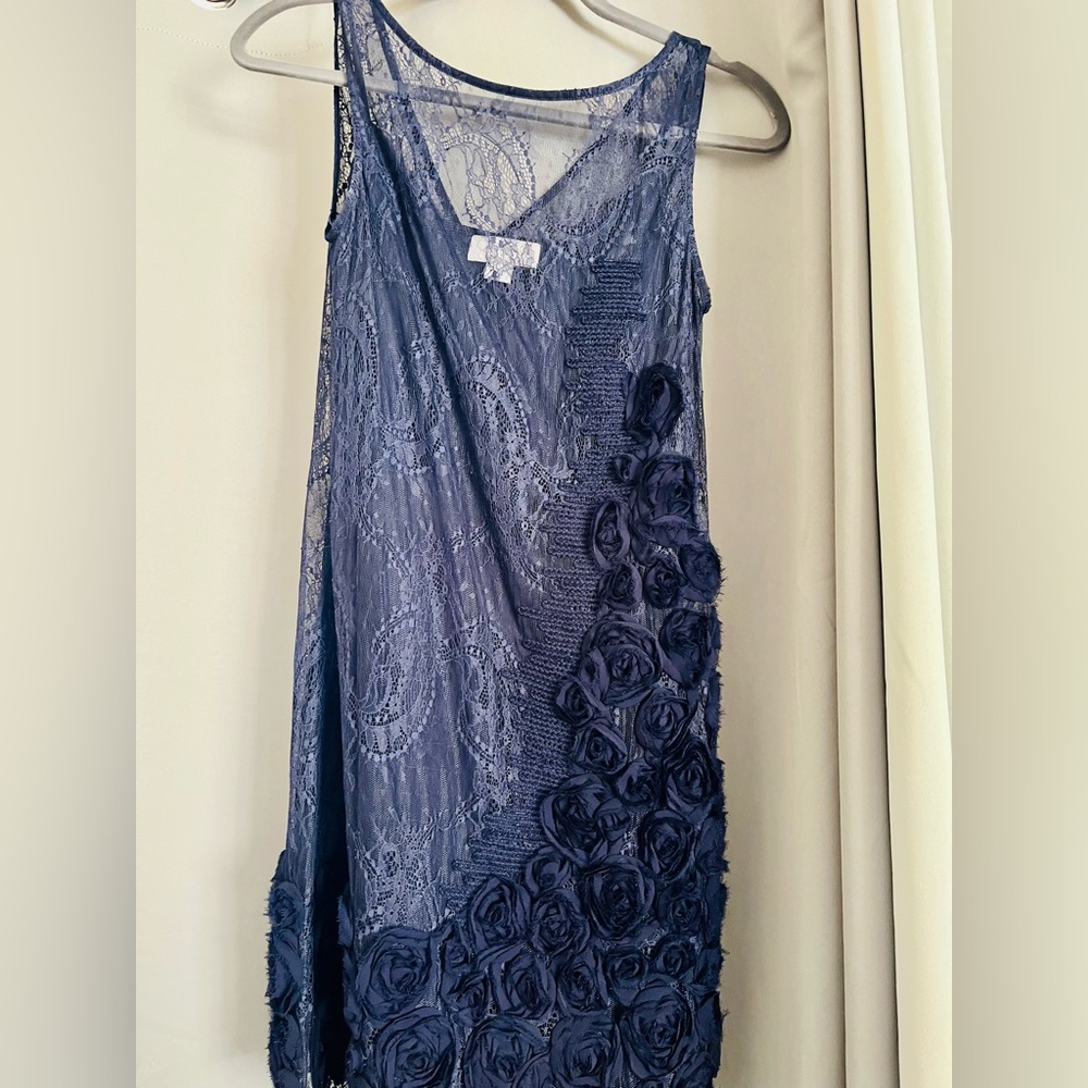 Navy blue lace dress with flower details along the side and bottom on the dress.